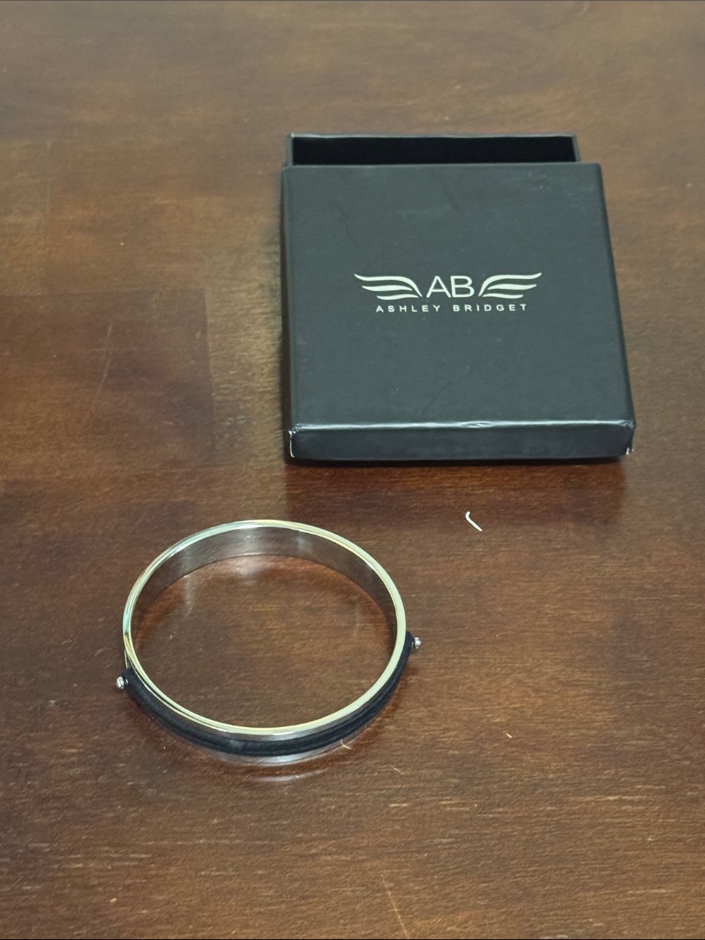 Ashley Bridget Silver-Tone Bangle with Black Inlay. Holds your hair ties & brac